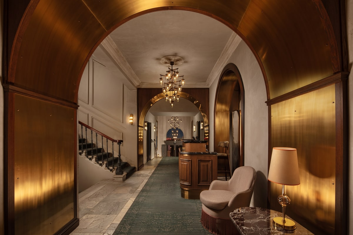Restored Camondo-era front desk under original chandeliers